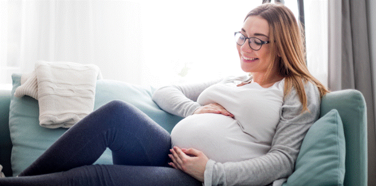 A pregnant woman wearing glasses