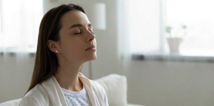 A woman taking a deep breath